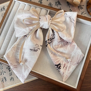 Détail du chouchou ruban bambou avec perles blanches et calligraphie de style chinois