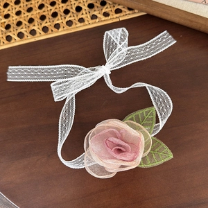 Détail de rose en mesh rose et feuilles brodées vertes sur ruban choker en dentelle