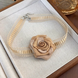 Detail of champagne satin rose choker with gold organza ribbon and adjustable chain