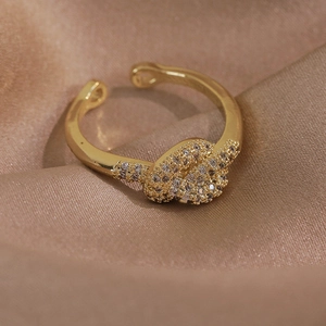 Gros plan d'une bague papillon dorée avec micro-zicons sur un tissu en satin luxueux