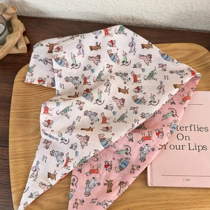 Detail of double-sided cotton headband with cute cartoon dog patterns on a wooden tray