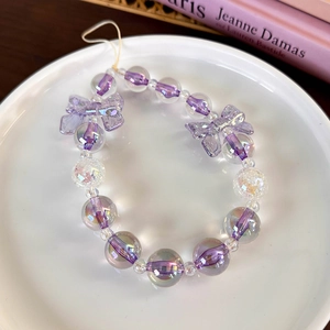 Close-up of sweet lavender beaded phone strap with cute purple bowknot charms