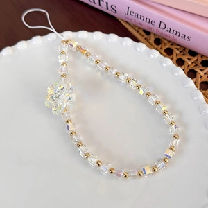 Detailed macro of vibrant glass beads and metal gold accents on the floral wrist strap
