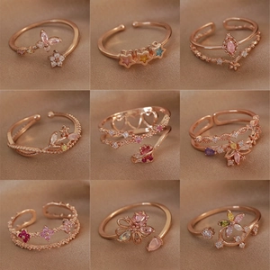 Set of nine rose gold adjustable rings with colorful zircon in floral and star designs