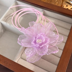 Detail of light purple organza flower necklace with delicate stitching and elastic cord