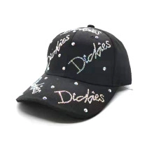 Detail of black baseball cap featuring colorful rhinestones and knitted mesh texture