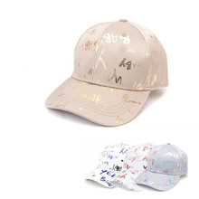 Close-up of street style graffiti baseball caps with colorful hand-drawn letter patterns