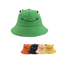 Detail showing various colors of frog-shaped cotton sun hats with 3D eyes and smile embroidery