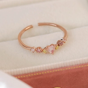 Detail of rose gold open ring with pink heart stone and zircon in a jewelry box