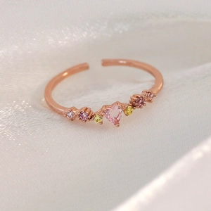 Detailed macro view of an adjustable rose gold ring with a heart-shaped pink gemstone