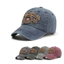 Detailed macro view showing five colors of retro washed cotton baseball caps with embroidery