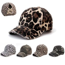 Detail of baseball caps with leopard print and crisscross elastic back for high ponytails