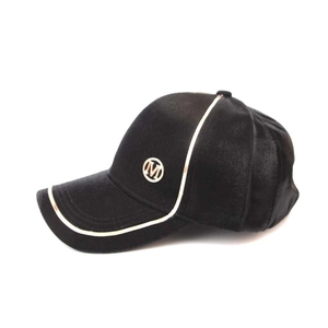 Detail of black baseball cap with white trim and embroidered M logo on the side