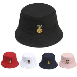 Detail view of cotton bucket hats with pineapple embroidery in five different colors
