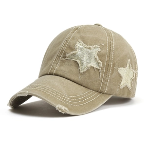 Detail showing vintage washed khaki cotton cap with frayed star patches and white stitching