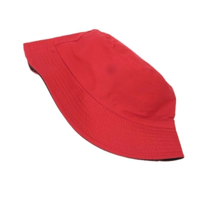 Detail of a red cotton bucket hat showing parallel stitching on the brim and black lining