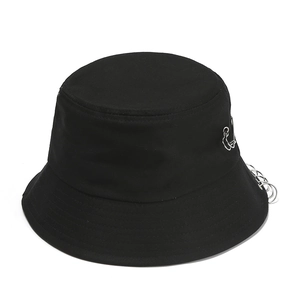 Black canvas bucket hat with punk silver metal rings and pin accent for street style fashion
