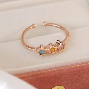 Macro view of adjustable rose gold star ring with colorful cubic zirconia inlay stones