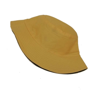 Detail view of double-sided yellow bucket hat with reinforced stitching and cotton texture