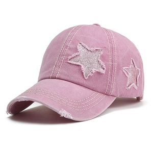 Distressed washed pink denim baseball cap featuring sparkly star patch and ripped details