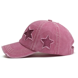 Vintage washed pink baseball cap with sequined star patches and distressed frayed details