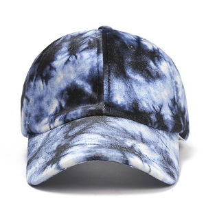 Detail view of tie-dye baseball cap featuring soft velvet texture and curved brim