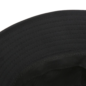 Macro detail of inner stitching and cotton twill fabric on a black bucket hat