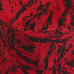 Detailed macro view of the red and black splatter print on twill cotton bucket hat