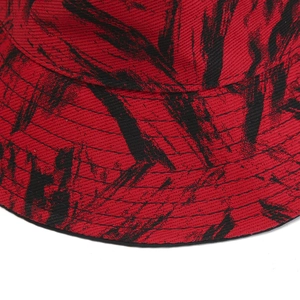 Detail of red and black bucket hat with graffiti pattern and parallel brim stitching