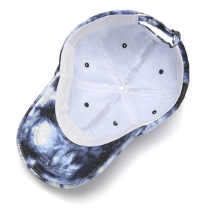Detail view of tie-dye baseball cap interior with vintage metal buckle and white lining