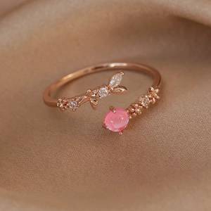 Detail of rose gold adjustable floral ring with pink opal and pavé zircon stones