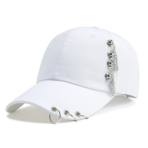 Detailed close-up of white cotton baseball cap featuring silver metal rings and chain charms