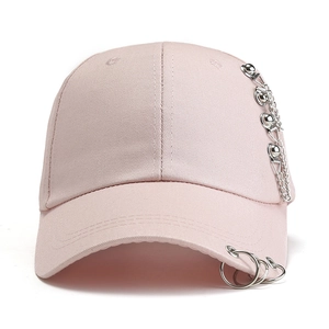Detail of light pink baseball cap with silver metal rings and punk chain decoration