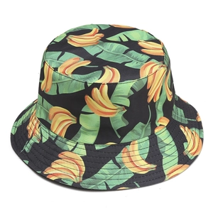 Fashionable reversible bucket hat featuring tropical banana and palm leaf print on black