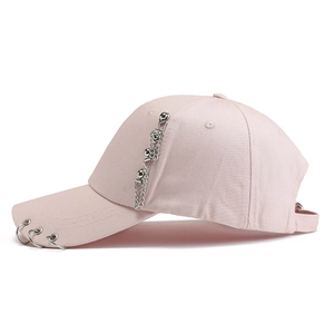 Close-up of pink baseball cap with metal rings and decorative chain detail