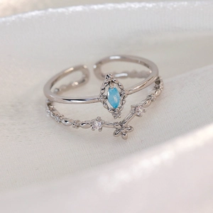 Detailed close-up of a double-layer silver adjustable ring with marquise blue zircon
