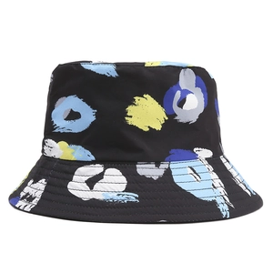 Close-up of a black bucket hat with abstract blue and yellow graffiti print and stitching
