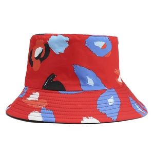 Detailed view of the red bucket hat featuring colorful abstract oil painting prints