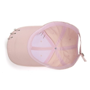 Pink cotton baseball cap featuring metal rings decoration and adjustable buckle