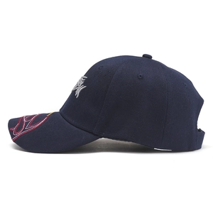 Detail of 3D fish embroidery on navy twill cotton baseball cap with tricolor brim