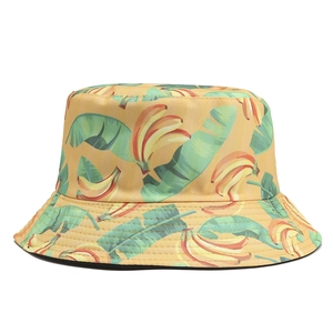 Close-up of banana and leaf print on yellow cotton bucket hat with stitched brim