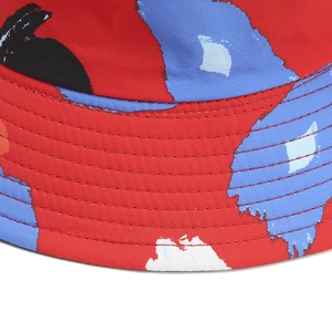 Detail of red bucket hat with abstract print and multi-row stitching on the brim