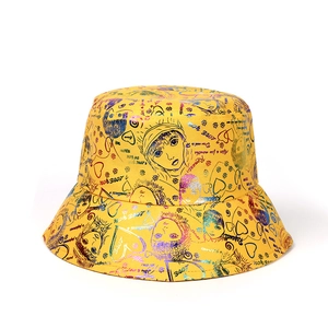 Yellow bucket hat featuring colorful graffiti patterns and anime character artwork