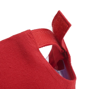 Rear view of red cotton baseball cap featuring an adjustable velcro strap closure