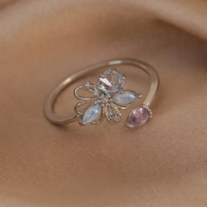 Detailed close-up of adjustable silver ring with blue and purple teardrop zircon stones