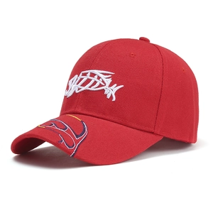 Detailed close-up of 3D fish embroidery and wave patterns on a red cotton baseball cap