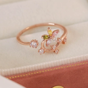 Macro shot of rose gold flower ring with colorful marquise zircons in a jewelry box