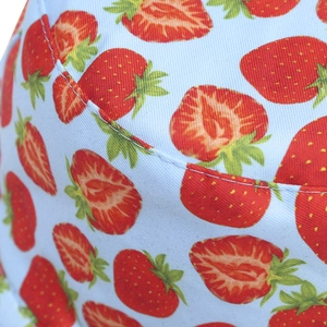 Double-sided sun hat featuring fresh light blue fabric and realistic strawberry print pattern