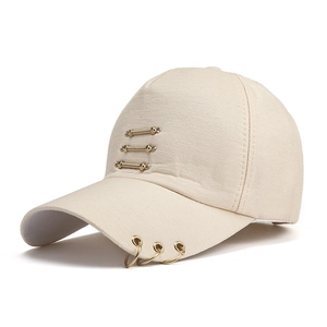Detail of beige canvas baseball cap featuring three gold metal rings and stripe accents