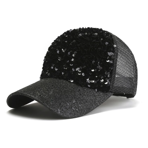 Detail of black sequined baseball cap featuring breathable mesh and shimmering brim texture